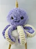 A plush toy octopus with a narwhal horn sits on a plain background. Produktbild-Vorschau