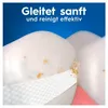 Close-up of teeth with a dental floss strip, with marketing text in German. Produktbild-Vorschau