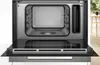 An open microwave oven with a clean interior. Anteprima dell’immagine prodotto