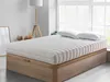 A mattress on a wooden bed frame in a bedroom setting. Produktbild-Vorschau