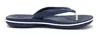 A side view of a navy blue Crocs Crocband Flip sandal with a white stripe around the sole, isolated on a white background. Produktbild-Vorschau