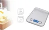 A kitchen scale with informational graphics, placed next to ingredients for baking. Náhľad obrázku produktu