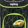 A close-up view of the front of a black school backpack with a geometric pattern and a yellow car sticker. Podgląd zdjęcia produktu