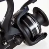 Close-up view of a black fishing reel with silver accents. Produktbild-Vorschau