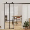 A sliding glass door with a metal frame is shown in a room with a dining table and chairs. Náhled obrázku produktu