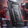 A black phone case with a kickstand is shown in a futuristic, industrial setting with robotic arms. Produktbild-Vorschau