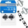 A product package containing Shimano SPD cleat set components, including the cleats themselves, screws, and mounting plates. Produktbild-Vorschau