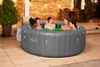 People relaxing in an inflatable hot tub on a patio at dusk. Produktbild-Vorschau