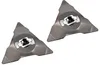 Two triangular lawnmower blades with white and black central fittings are shown against a white background. Náhled obrázku produktu