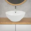 A white ceramic sink with a chrome faucet sits on a wooden countertop. Náhľad obrázku produktu