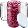 Three glass jars, one filled with chopped red cabbage, and a white lid are arranged on a white background. Podgląd zdjęcia produktu