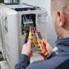 A person is using a voltage tester to check an electrical unit. Náhľad obrázku produktu
