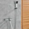 A modern bathroom shower fixture with a thermostat control and a handheld showerhead, mounted on a tiled wall next to wooden blinds. Náhľad obrázku produktu