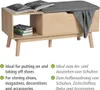 A wooden bench with a gray upholstered seat and a storage compartment, shown with books and a blanket. Náhled obrázku produktu