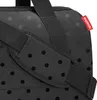 A close-up view of a black bag with a polka dot pattern and a red brand tag. Anteprima dell’immagine prodotto