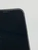 A close-up of the top corner of a black smartphone, showing some minor cracks on the screen. Produktbild-Vorschau