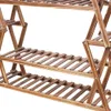A close-up view of a wooden plant stand with multiple shelves. Anteprima dell’immagine prodotto