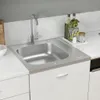 A stainless steel kitchen sink with a faucet and some kitchen accessories on a white countertop. Náhľad obrázku produktu