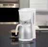 A coffee maker with a thermal carafe and a cup of coffee on a kitchen counter. Náhľad obrázku produktu