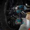 A gloved hand is using a cordless impact wrench to tighten a lug nut on a car wheel. Podgląd zdjęcia produktu