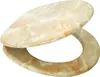 A toilet seat and lid made of marble-like material. Produktbild-Vorschau