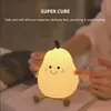 A person's hand is touching a pear-shaped night light. Produktbild-Vorschau