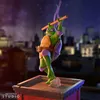 A statue of Donatello from Teenage Mutant Ninja Turtles on a rooftop at night. Podgląd zdjęcia produktu