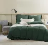 A bedroom scene with a bed, chair, and lamp. Podgląd zdjęcia produktu