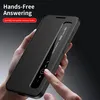 A hand is holding a black smartphone case with a flip cover that has a transparent window. The case is open, showing the phone screen with call interface elements. Text overlays describe features. Anteprima dell’immagine prodotto