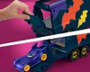 A hand is shown interacting with a toy Batmobile transporter, with the Batmobile itself visible inside. Anteprima dell’immagine prodotto