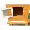 A close-up view of a wooden animal hutch, showing an open door with a wire mesh screen and a pull-out tray. Produktbild-Vorschau