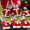 Christmas table setting with Santa-themed cutlery holders. Produktbild-Vorschau