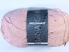 A ball of pink yarn with black and gray speckles, wrapped in a paper band with brand and product information. Produktbild-Vorschau