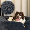 A dog is lying comfortably in a plush dog bed. Anteprima dell’immagine prodotto