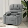 A gray recliner chair with cup holders and side pockets is shown in a room with a plant and books. Produktbild-Vorschau