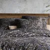 A close-up view of a bed with paisley patterned bedding and pillows. Produktbild-Vorschau