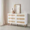A white dresser with rattan drawer fronts is displayed in a room with sheer curtains. Produktbild-Vorschau
