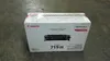 A Canon toner cartridge box is placed on a concrete floor. Náhľad obrázku produktu