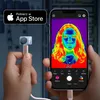 A hand holds a thermal camera attachment connected to a smartphone, displaying a thermal image of a person's face. Voir les images du produit