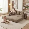 A woman reads a book on a modular sofa while a child and dog play on the floor in front of it. Produktbild-Vorschau