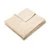 A folded beige blanket with a ribbed texture is shown against a white background. Produktbild-Vorschau