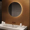 A modern bathroom sink area with a round, illuminated mirror above a marble countertop. Produktbild-Vorschau