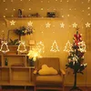 A room decorated for Christmas with string lights, a small Christmas tree, and festive ornaments. Náhled obrázku produktu
