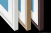 Three different colored frames for a TV are shown side-by-side against a black background. Voir les images du produit