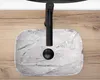 A top-down view of a marble sink with a black faucet. Náhled obrázku produktu