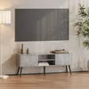 A modern living room setup with a TV stand and a television mounted on the wall. Podgląd zdjęcia produktu