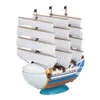 A model of a ship with white sails, a blue and brown hull, and a whale-shaped front. Anteprima dell’immagine prodotto