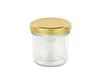 A clear studio shot of a glass jar with a gold lid. Náhled obrázku produktu