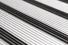 A close-up, angled view of a ribbed surface with alternating silver and black stripes. Náhled obrázku produktu
