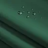 Close-up of a green fabric with water droplets on it, showing its water-repellent properties. Produktbild-Vorschau